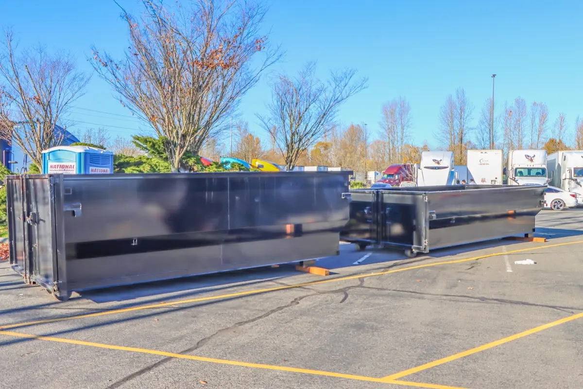 Professional dumpster rental service with roll-off container on residential driveway in Oil City